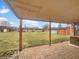 Covered brick patio overlooking a large, grassy backyard with a storage shed at 3509 River Bluff Rd, Anderson, IN 46012
