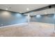 Spacious finished basement with neutral carpeting, recessed lighting, and painted blue walls at 3705 River Rd, Columbus, IN 47203