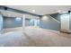 Spacious finished basement with neutral carpeting, recessed lighting, and painted blue walls at 3705 River Rd, Columbus, IN 47203
