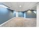 Spacious finished basement area with neutral carpeting and door to storage area at 3705 River Rd, Columbus, IN 47203