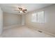 Neutral bedroom features plush carpet, ceiling fan, and single window with blinds at 3705 River Rd, Columbus, IN 47203