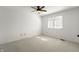 Bedroom features neutral carpeting, a ceiling fan, and a window that provides natural light at 3705 River Rd, Columbus, IN 47203