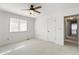 Bedroom features neutral carpeting, a ceiling fan, and a window that provides natural light at 3705 River Rd, Columbus, IN 47203