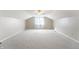 Bedroom features neutral carpeting, a ceiling fan, and attic ceilings at 3705 River Rd, Columbus, IN 47203