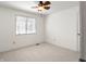 Bright bedroom with natural light, featuring a ceiling fan and neutral carpeting at 3705 River Rd, Columbus, IN 47203