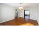 Dining room featuring hardwood floors, a modern chandelier, and open access to the living spaces at 3705 River Rd, Columbus, IN 47203