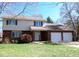 Charming two-story home with brick and siding, featuring an attached two-car garage and a well-maintained front lawn at 3705 River Rd, Columbus, IN 47203