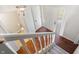Bright foyer showcasing hardwood floors, a staircase, and a view of the front door at 3705 River Rd, Columbus, IN 47203
