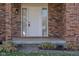 Close-up of the front door showcasing the brick facade and modern exterior lighting at 3705 River Rd, Columbus, IN 47203