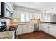 Bright kitchen featuring granite countertops, stainless steel appliances, and white cabinetry at 3705 River Rd, Columbus, IN 47203