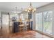 Open concept with eat-in kitchen island, pendant lighting, granite counters, and backyard view at 3705 River Rd, Columbus, IN 47203