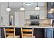 This kitchen features granite counters, stainless appliances, and pendant lighting at 3705 River Rd, Columbus, IN 47203