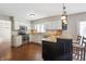 Well-lit kitchen with granite countertops, white cabinets, stainless appliances, and hardwood floors at 3705 River Rd, Columbus, IN 47203