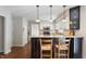 Kitchen with island featuring granite countertop, seating, and views to the stainless appliances and cabinets at 3705 River Rd, Columbus, IN 47203