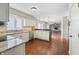 Open kitchen layout leads to a living room with fireplace, granite countertops, and stainless appliances at 3705 River Rd, Columbus, IN 47203