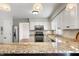 Kitchen view features granite countertops, stainless steel appliances, and an eat-in bar at 3705 River Rd, Columbus, IN 47203
