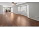 Open concept living room boasts hardwood floors and bright bay windows connecting to the kitchen at 3705 River Rd, Columbus, IN 47203