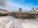 Snow covered backyard with a wood deck and a view of the home's rear exterior at 3936 Par Dr, Indianapolis, IN 46268