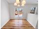 Sunny dining area features new flooring and glass doors to a deck overlooking the snow-covered backyard at 3936 Par Dr, Indianapolis, IN 46268