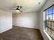 Spacious carpeted bedroom featuring neutral walls, a ceiling fan, and a window overlooking the yard at 3951 Narrowleaf Ct, Indianapolis, IN 46235