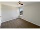 Spacious carpeted bedroom featuring neutral walls, a ceiling fan, and a window overlooking the neighborhood at 3951 Narrowleaf Ct, Indianapolis, IN 46235