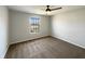 Cozy bedroom with plush carpeting, a ceiling fan, and natural light from the window at 3951 Narrowleaf Ct, Indianapolis, IN 46235