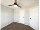 Carpeted bedroom with neutral walls featuring a ceiling fan and closet for storage at 3951 Narrowleaf Ct, Indianapolis, IN 46235