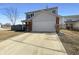 Charming two-story home with a two-car garage and a long driveway and manicured lawn at 3951 Narrowleaf Ct, Indianapolis, IN 46235