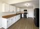 Modern kitchen with white cabinets, sleek black appliances, and butcher block countertops at 3951 Narrowleaf Ct, Indianapolis, IN 46235