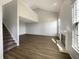 Bright living room with beautiful hardwood flooring, a fireplace, and vaulted ceilings at 3951 Narrowleaf Ct, Indianapolis, IN 46235