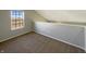 Loft space features neutral carpet, a window overlooking the neighborhood, and a freshly painted wall at 3951 Narrowleaf Ct, Indianapolis, IN 46235