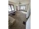 Empty living room featuring a fireplace and windows providing natural light, needs repairs at 408 E Monroe St, Alexandria, IN 46001