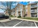 View of apartment building, featuring multiple windows and a parking area with a black truck at 4925 Opal Ridge Ln # 309, Indianapolis, IN 46237