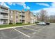 Apartment building with balconies and tan siding, enhanced by green space and a parking area at 4925 Opal Ridge Ln # 309, Indianapolis, IN 46237