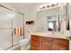 Clean bathroom with glass shower, tile flooring, wooden cabinets, and well-lit vanity at 4925 Opal Ridge Ln # 309, Indianapolis, IN 46237