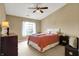 Comfortable bedroom with a ceiling fan, a large window, and a well-lit interior at 4925 Opal Ridge Ln # 309, Indianapolis, IN 46237
