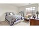 Bright bedroom with a comfortable bed, chair and a treadmill by the window at 4925 Opal Ridge Ln # 309, Indianapolis, IN 46237