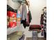 Walk-in closet with ample shelving and hanging space for storage, filled with clothes and boxes at 4925 Opal Ridge Ln # 309, Indianapolis, IN 46237