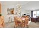 Open dining area with a chandelier adjacent to the living room and kitchen with barstool seating at 4925 Opal Ridge Ln # 309, Indianapolis, IN 46237