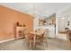 Comfortable dining area with seating for four, view of kitchen, and accent wall at 4925 Opal Ridge Ln # 309, Indianapolis, IN 46237