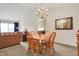 Bright dining area showcasing table, four chairs, chandelier, and view into living room and bedroom at 4925 Opal Ridge Ln # 309, Indianapolis, IN 46237