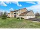 Apartment building with brick and siding, garages, and a well-maintained lawn at 4925 Opal Ridge Ln # 309, Indianapolis, IN 46237
