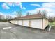 Detached garages with white doors and tan siding, providing ample parking at 4925 Opal Ridge Ln # 309, Indianapolis, IN 46237