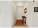 Bright apartment hallway featuring white walls, a small table, a mirror, and a white front door at 4925 Opal Ridge Ln # 309, Indianapolis, IN 46237