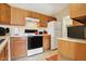 Efficient kitchen with appliances and ample counter space, adjacent to a laundry area at 4925 Opal Ridge Ln # 309, Indianapolis, IN 46237