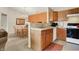 Updated kitchen with stainless steel sink, and view into adjacent dining area and living room at 4925 Opal Ridge Ln # 309, Indianapolis, IN 46237