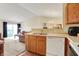 Kitchen with white dishwasher and stainless steel sink, leading into an open living space at 4925 Opal Ridge Ln # 309, Indianapolis, IN 46237