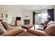 Cozy living room with brown couches, fireplace, TV, and sliding door to the outside at 4925 Opal Ridge Ln # 309, Indianapolis, IN 46237