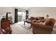 Comfortable living room featuring a cozy seating area, fireplace, and sliding door to balcony at 4925 Opal Ridge Ln # 309, Indianapolis, IN 46237