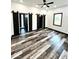 Spacious bedroom with barn doors, modern ceiling fan, and wood-look flooring at 511 N Clark St, Lebanon, IN 46052